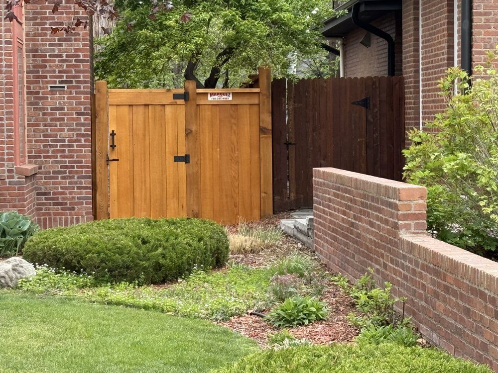 Cedar fence with retaining wall landscaping